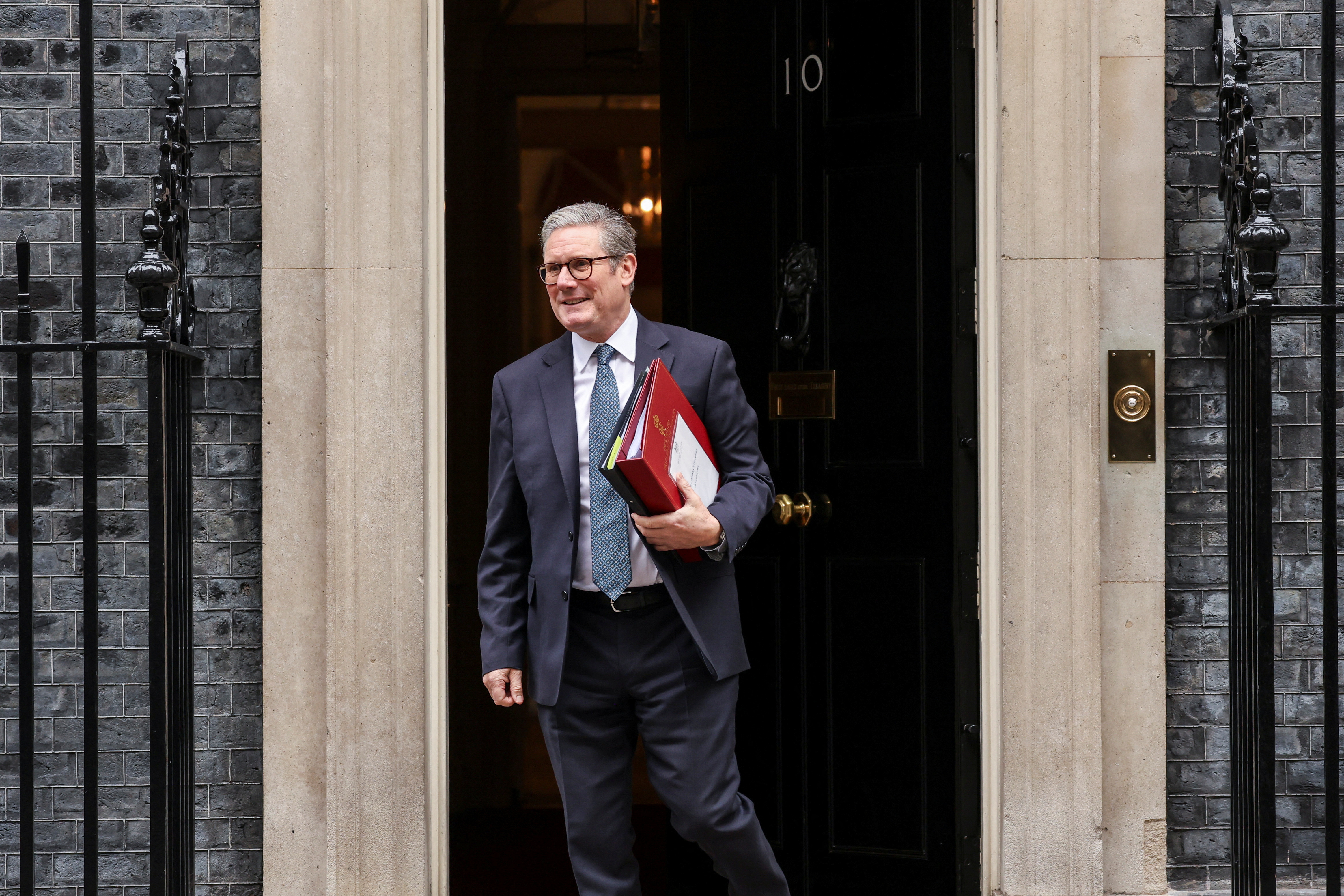 Britain's Chancellor of the Exchequer Reeves carries the red budget box at Downing Street, in London