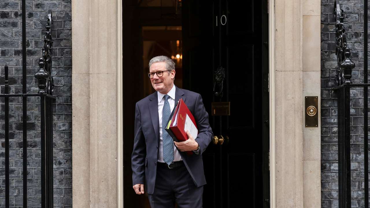 Britain's Chancellor of the Exchequer Reeves carries the red budget box at Downing Street, in London