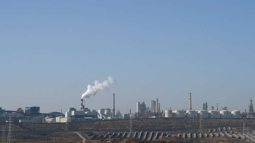 FILE PHOTO: Solar panels lie in front of factories at Jinjie Industrial Park in Shenmu
