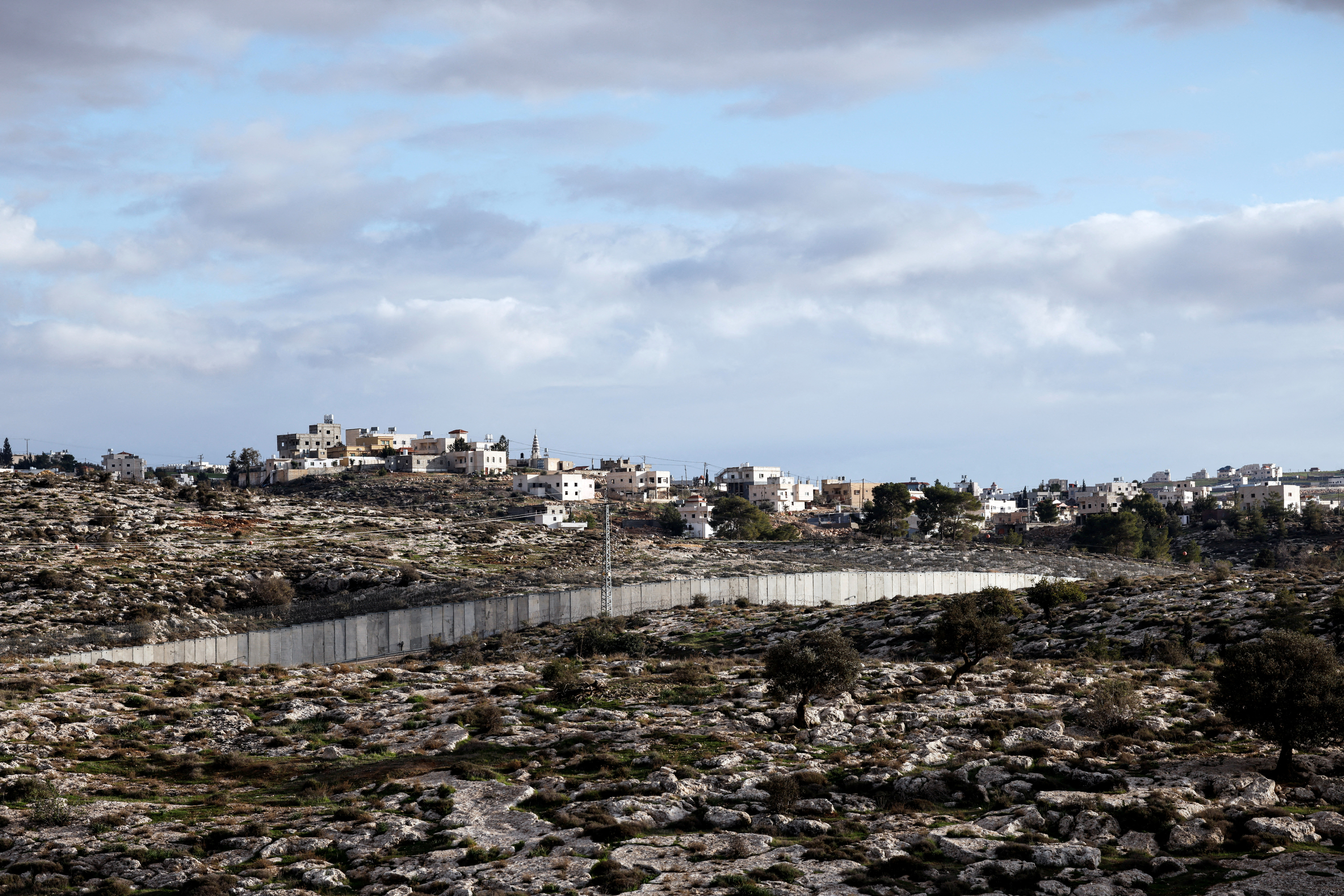 FILE PHOTO: A view of the southern part of the Israeli-occupied West Bank and the concrete barrier wall separating Israel and the West Bank, as seen from near Kibbutz Lahav