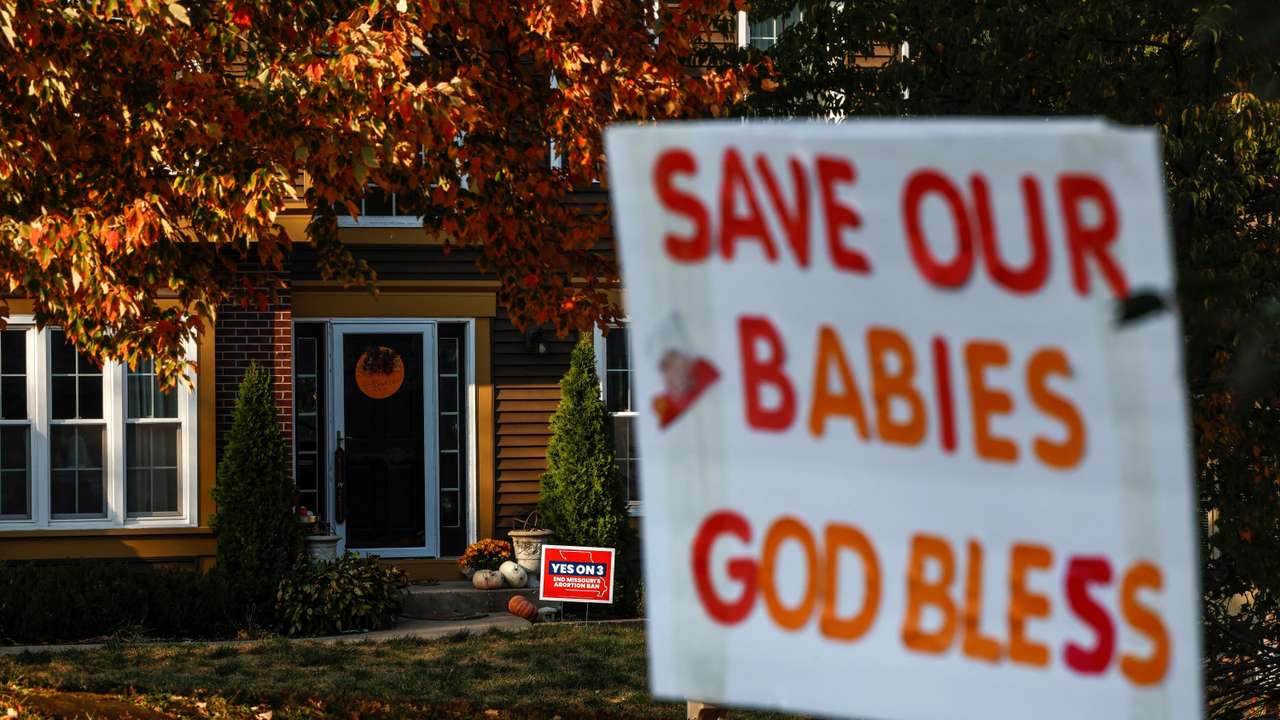 Competing yard signs for and against Amendment 3, a measure that would establish a constitutional right to abortion dot neighborhoods in Missouri