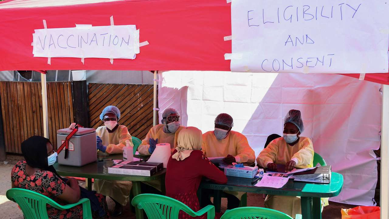 Ugandan doctors attend the contacts of a patient who had tested positive, during the launch of the vaccination for the Sudan strain of Ebola virus, in Kampala