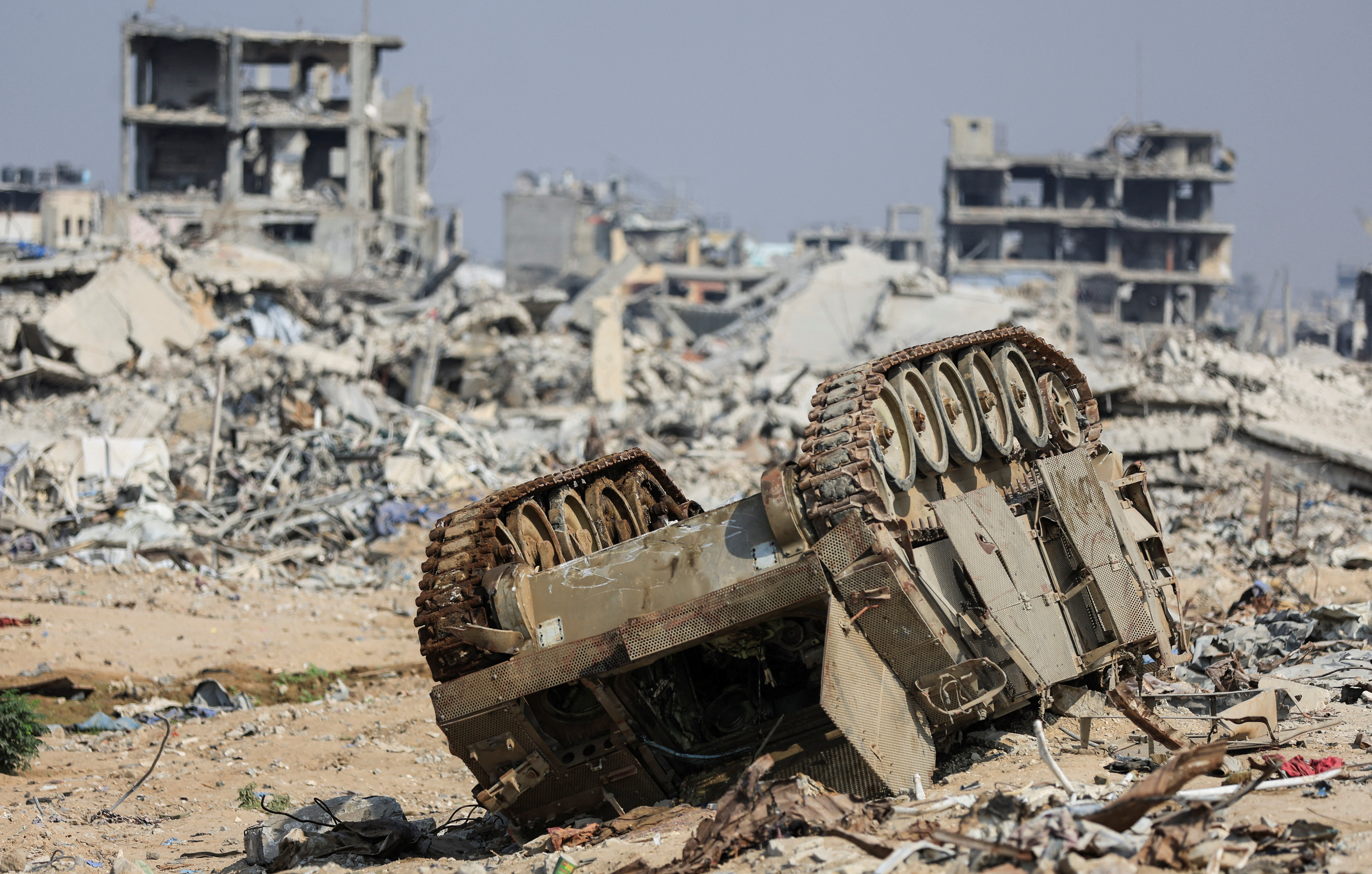 An armoured personnel carrier next to destroyed buildings after Israeli military operations in Gaza City
