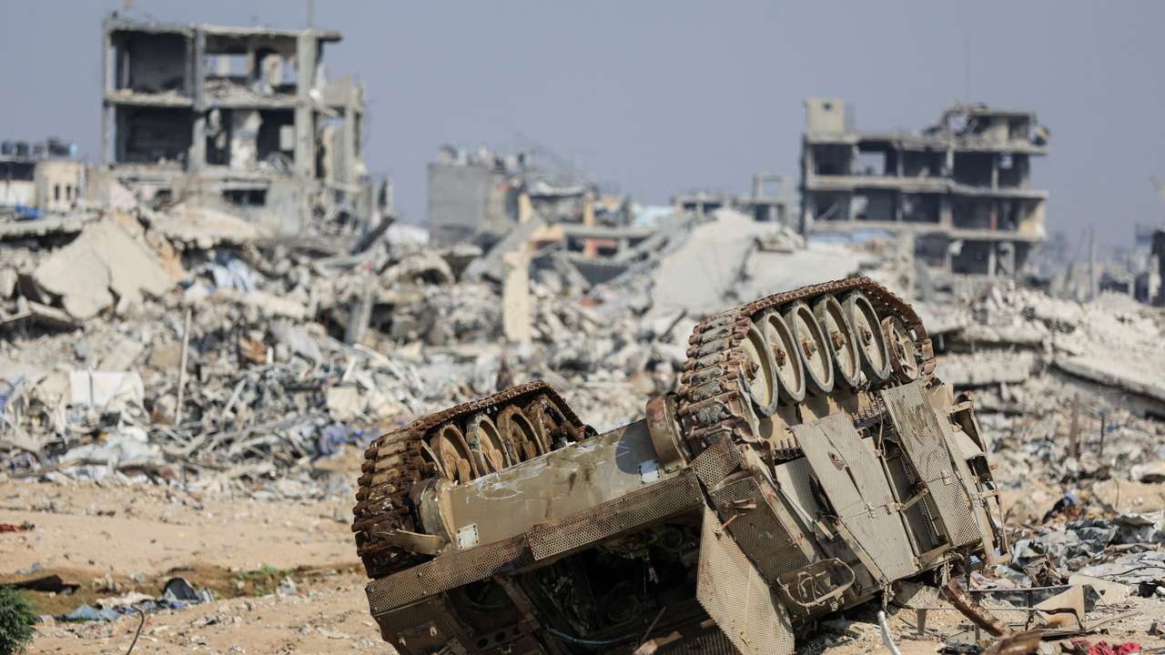 An armoured personnel carrier next to destroyed buildings after Israeli military operations in Gaza City