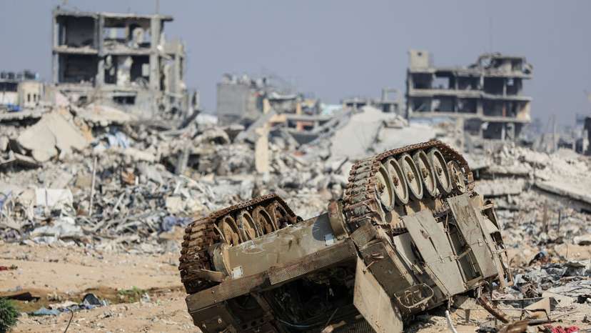 An armoured personnel carrier next to destroyed buildings after Israeli military operations in Gaza City