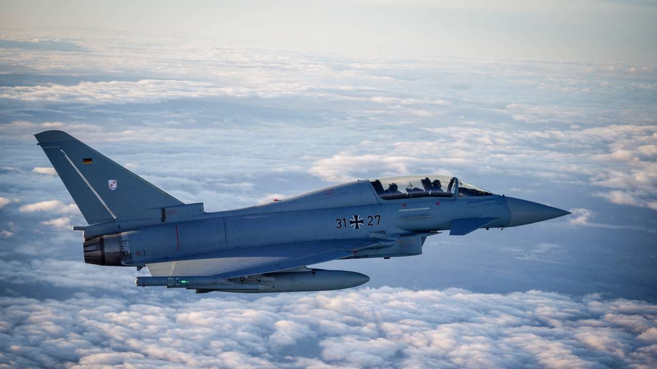 FILE PHOTO: A Eurofighter jet accompanies the flight of German Chancellor Olaf Scholz