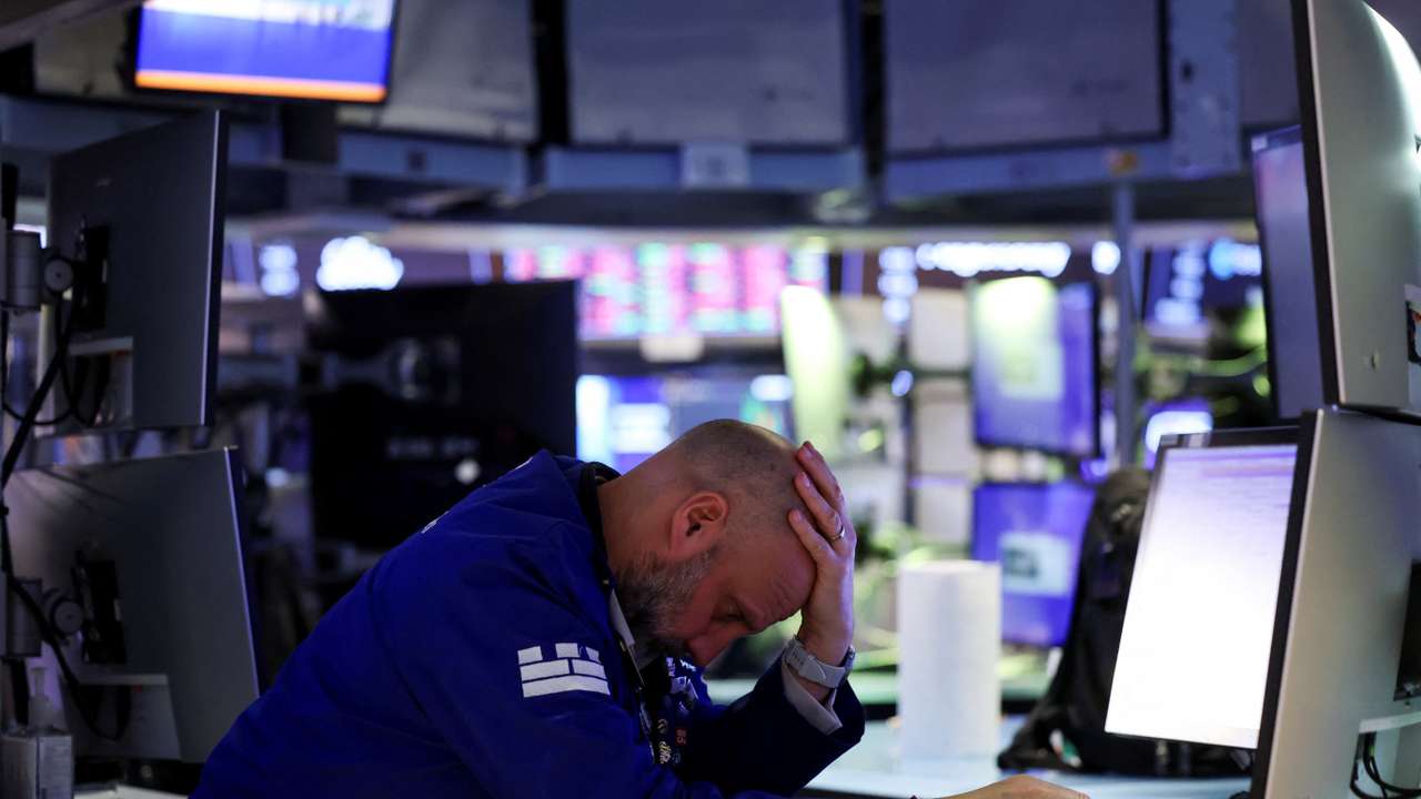Trader works during the closing bell, on the floor at the New York Stock Exchange (NYSE) in New York City
