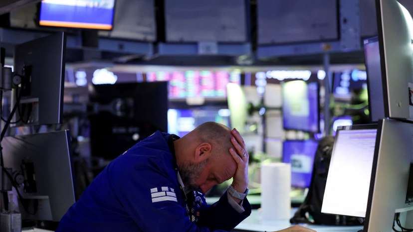 Trader works during the closing bell, on the floor at the New York Stock Exchange (NYSE) in New York City