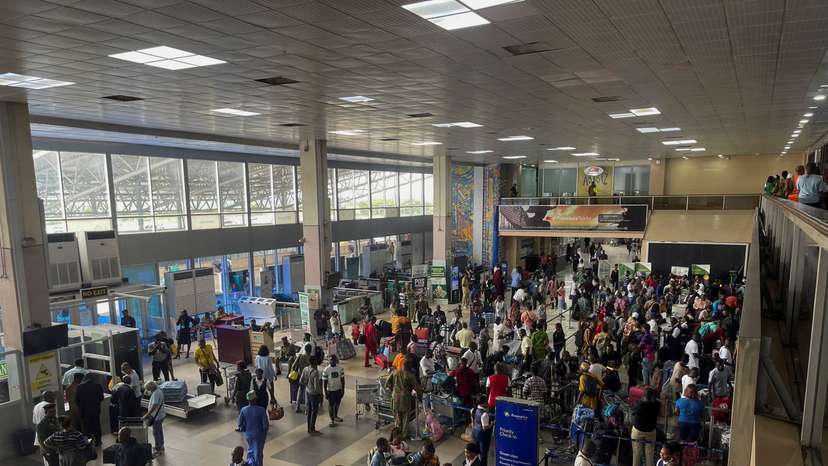 Passengers gather as they check-in their luggages at Murtala Muhammed International Airport in Lagos