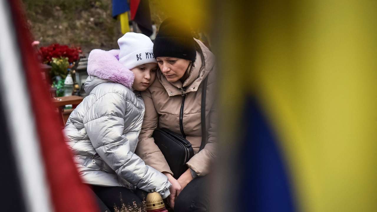 People visit graves of killed Ukrainian defenders, on the day of the second anniversary of Russia's attack on Ukraine, in Lviv