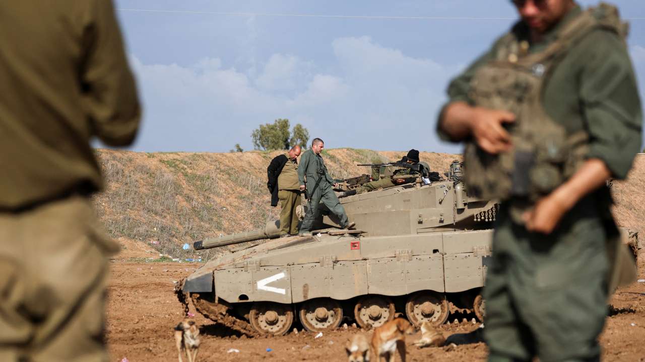 Israeli soldiers fire mortar shells near Israel's border with Gaza in southern Israel