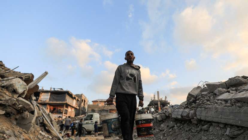 FILE PHOTO: A Palestinian carries water, in Jabalia refugee camp